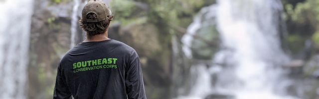Crew member looks at waterfall