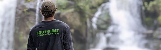 Crew member looks at waterfall